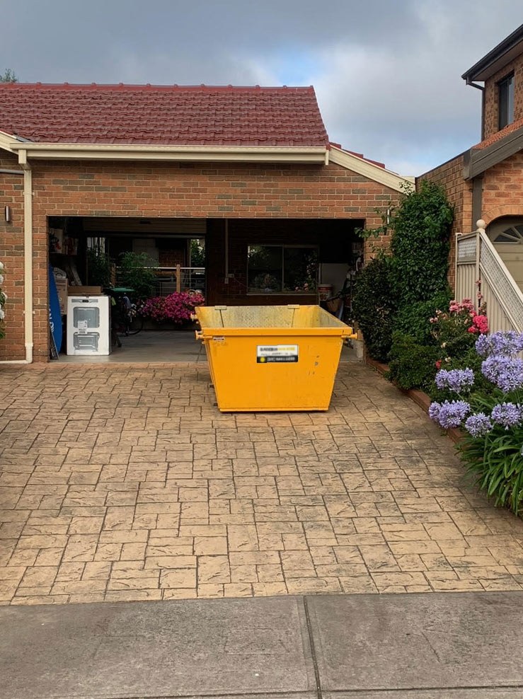 Skip bin on a driveway in Darebin
